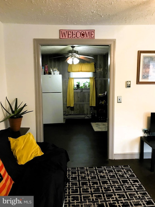 interior space with a baseboard radiator and a textured ceiling