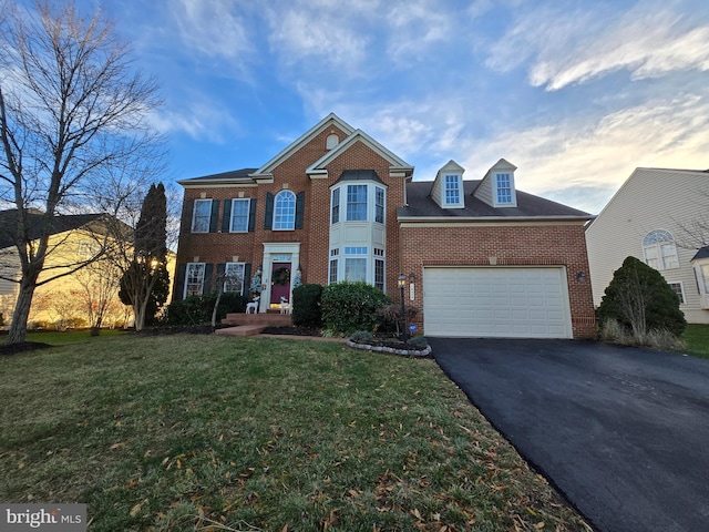 view of front of home featuring a garage and a yard