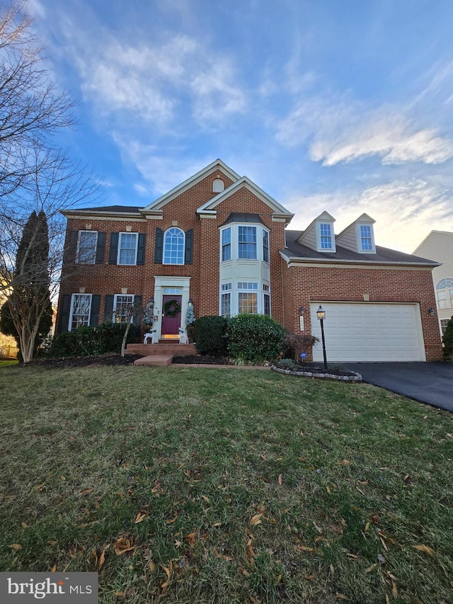 view of front facade with a front yard and a garage