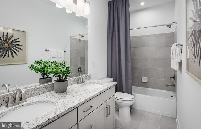 full bathroom featuring tile patterned flooring, vanity, shower / tub combo with curtain, and toilet