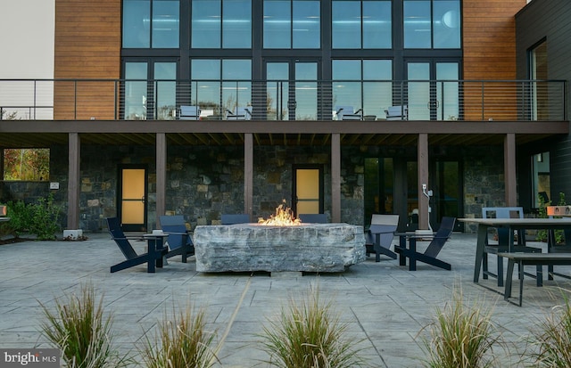 rear view of property with a patio area and a balcony