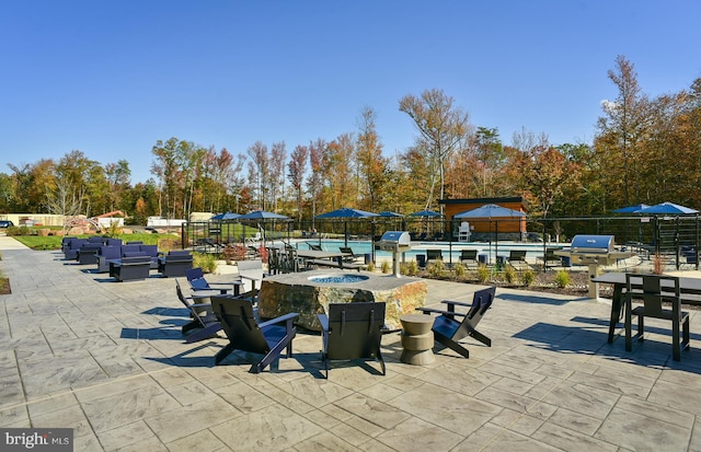 view of patio / terrace featuring an outdoor fire pit and a grill