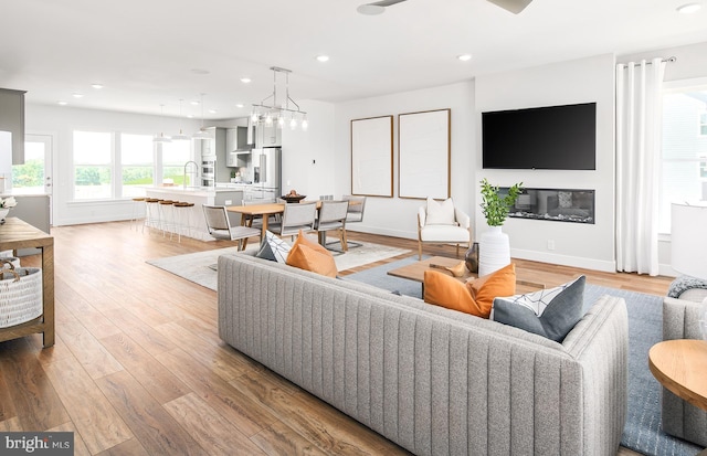 living room featuring sink and light wood-type flooring