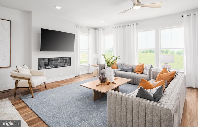 living room featuring ceiling fan and light wood-type flooring