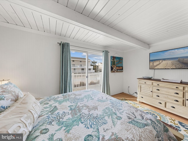 bedroom with wood ceiling, light wood finished floors, beam ceiling, and access to exterior