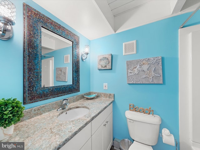 bathroom featuring toilet, a shower, vanity, and visible vents