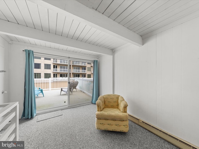 sitting room with a baseboard heating unit, beamed ceiling, and carpet floors