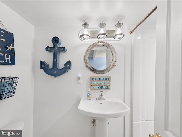 bathroom with toilet and a sink