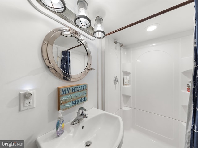 bathroom featuring a sink and a shower with shower curtain