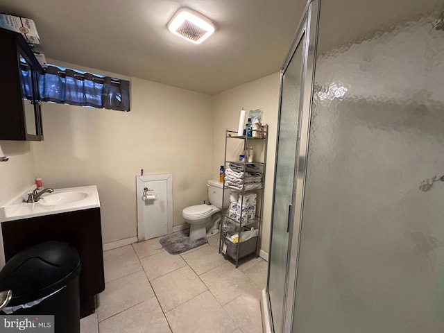 bathroom with a shower with door, vanity, tile patterned floors, and toilet