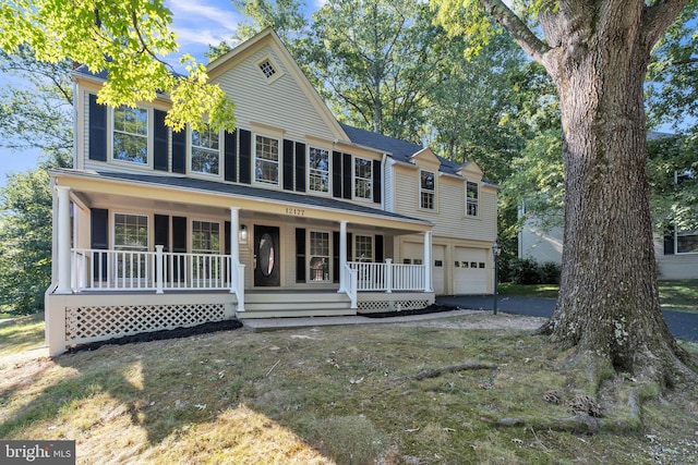 view of front of property featuring a porch and a garage