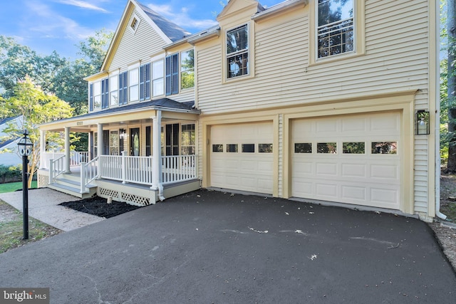 view of front of property with covered porch and a garage