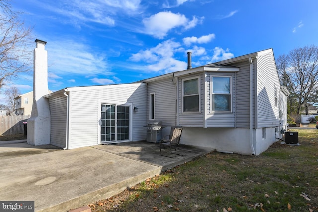 back of house with central AC unit and a patio