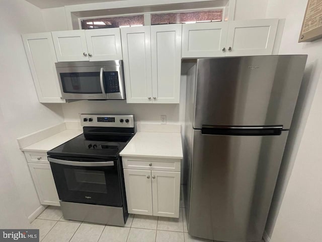 kitchen featuring white cabinetry, light tile patterned flooring, and appliances with stainless steel finishes