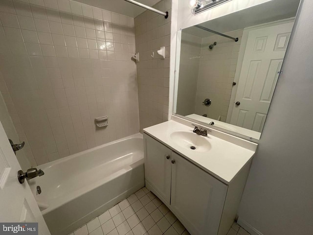 bathroom featuring vanity, tiled shower / bath combo, and tile patterned floors