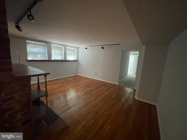 living room featuring track lighting and hardwood / wood-style flooring