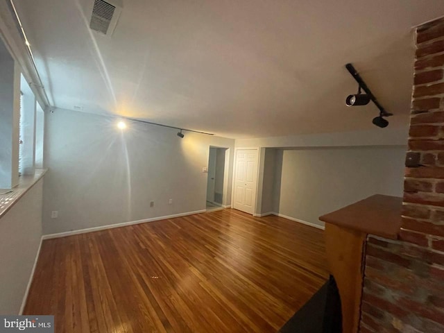 unfurnished living room featuring dark wood-type flooring