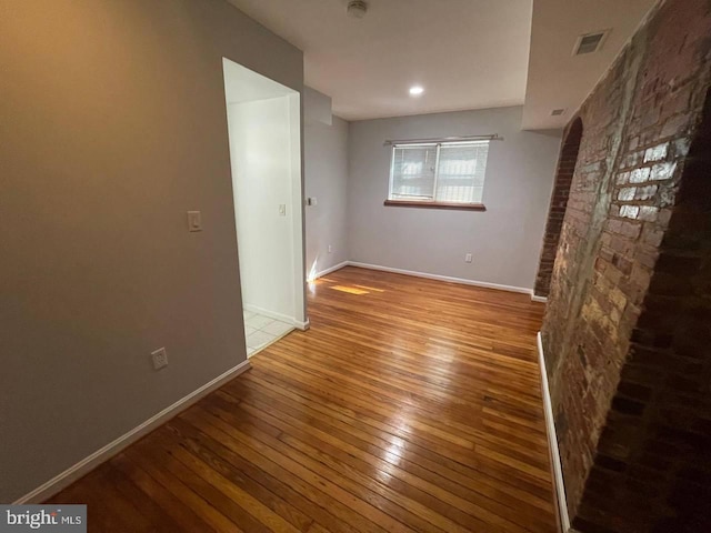 empty room with light hardwood / wood-style flooring