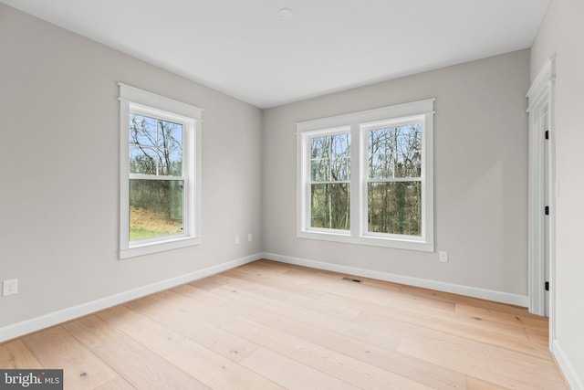 spare room featuring light hardwood / wood-style floors