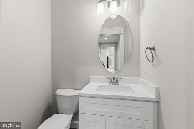 bathroom featuring vanity and toilet