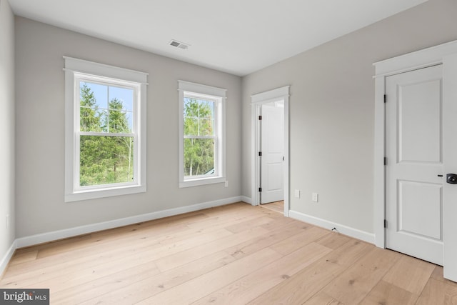 empty room featuring light hardwood / wood-style flooring and a healthy amount of sunlight