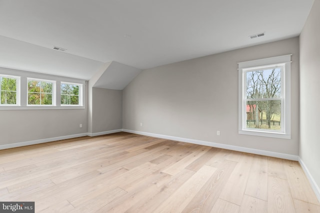 bonus room featuring lofted ceiling and light hardwood / wood-style floors