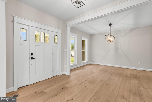 foyer featuring an inviting chandelier and light hardwood / wood-style floors