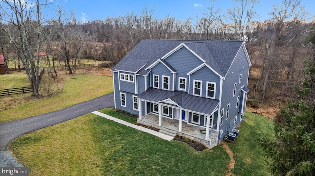 view of front of home with a front yard and covered porch