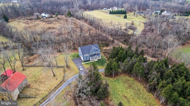 birds eye view of property with a rural view