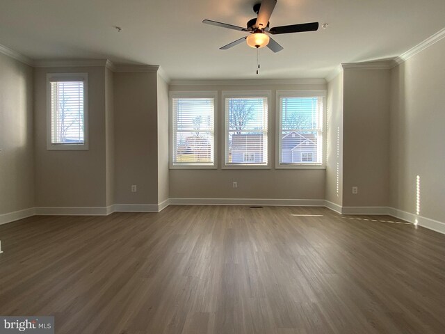 empty room featuring dark hardwood / wood-style floors, ceiling fan, and crown molding