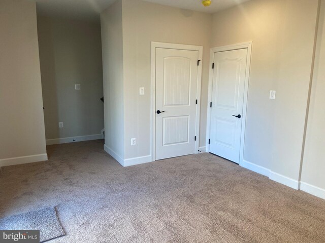 unfurnished bedroom with light carpet