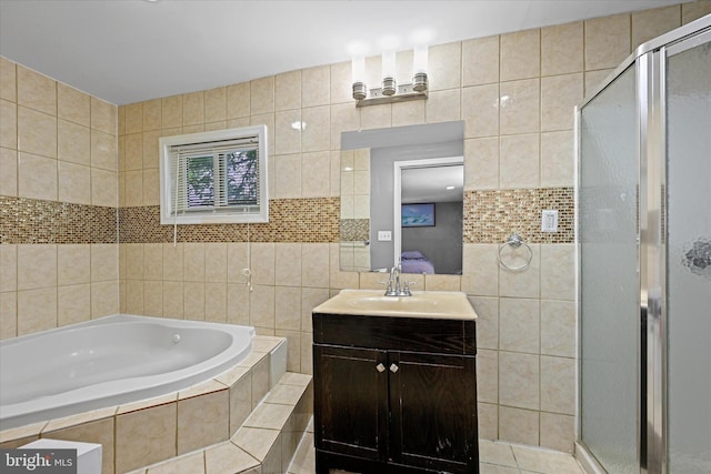 bathroom with vanity, tile walls, tile patterned flooring, and plus walk in shower