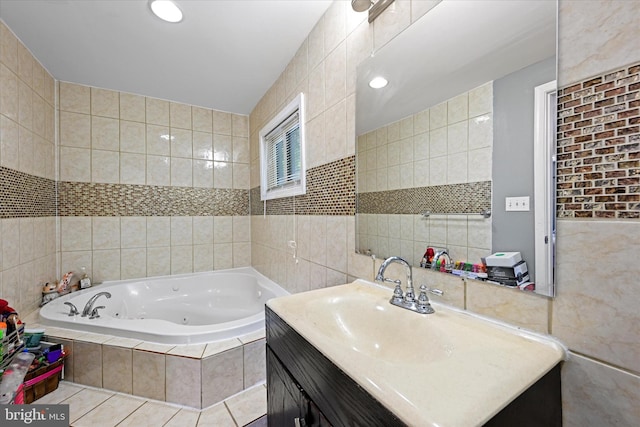 bathroom featuring tile walls, tiled tub, vanity, and tile patterned flooring