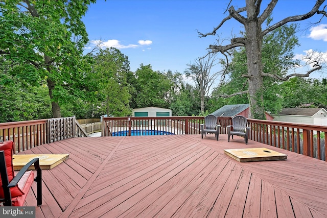 wooden terrace featuring a storage shed