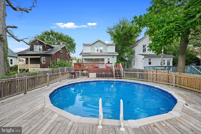 view of swimming pool featuring a deck