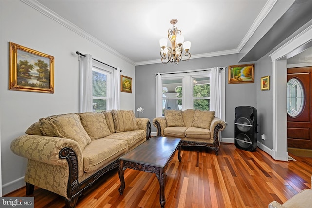 living room featuring an inviting chandelier, crown molding, and hardwood / wood-style floors