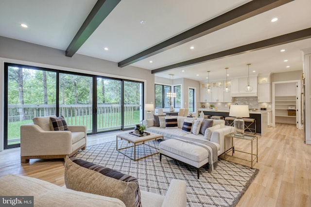 living room featuring beam ceiling and light hardwood / wood-style floors