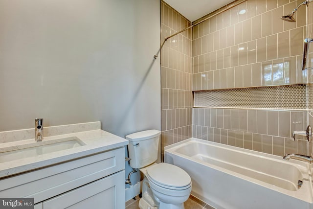 full bathroom featuring vanity, toilet, and tiled shower / bath