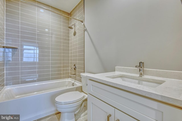 full bathroom featuring vanity, tiled shower / bath combo, and toilet