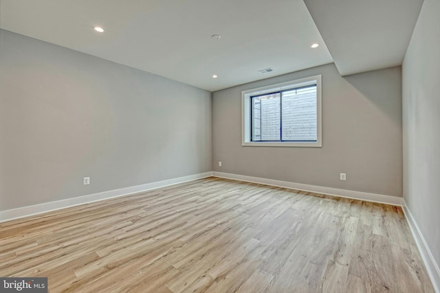 spare room featuring light wood-type flooring