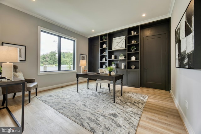 office space featuring crown molding and light hardwood / wood-style flooring