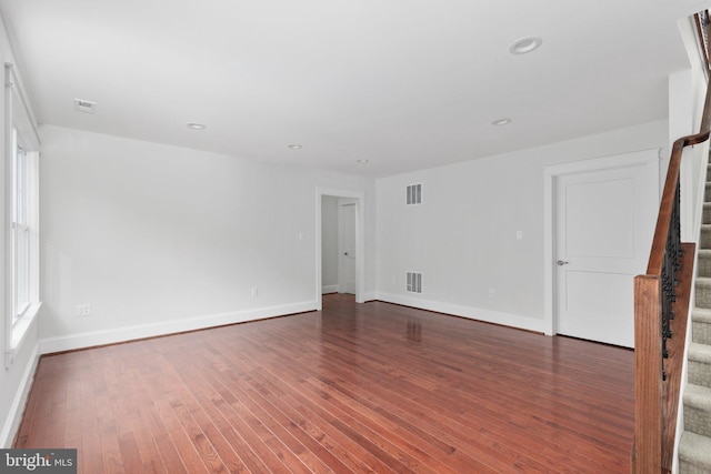 empty room with dark hardwood / wood-style flooring