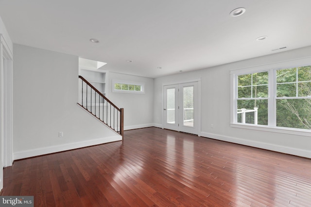 unfurnished living room featuring dark wood-type flooring