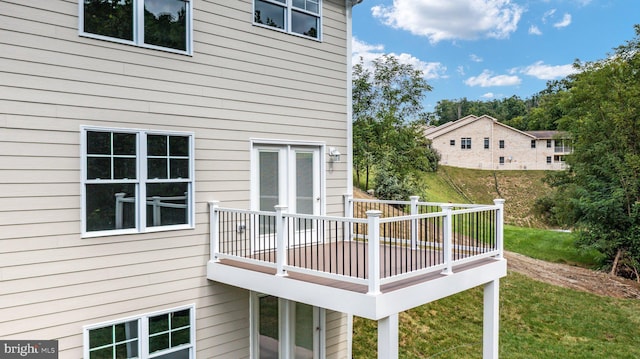 deck with a lawn and french doors