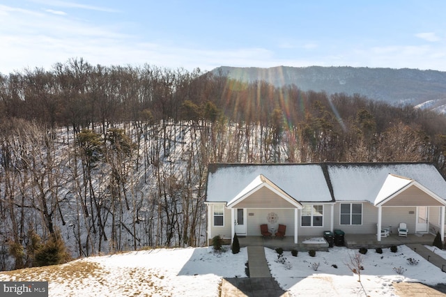 view of front of home with covered porch and a mountain view