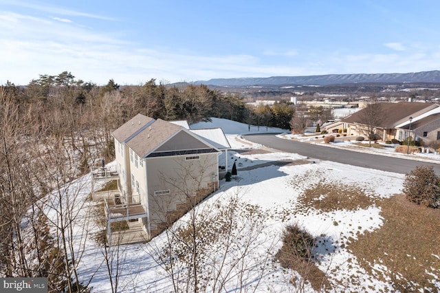 snowy aerial view with a mountain view