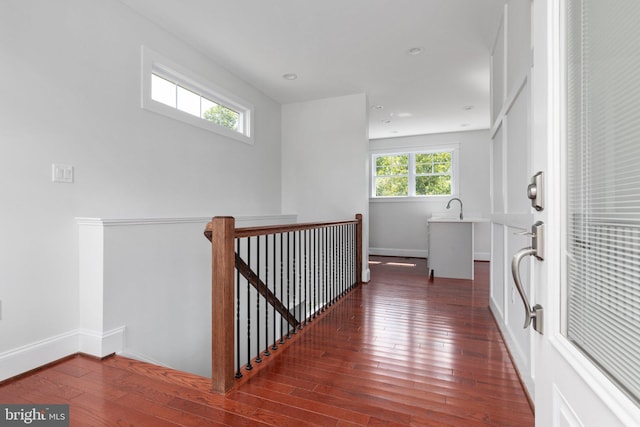 corridor featuring sink and dark hardwood / wood-style floors