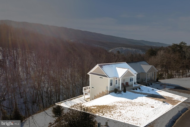 snowy aerial view featuring a mountain view