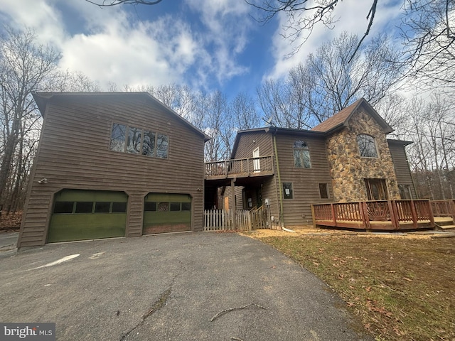 view of front of home featuring a garage and a deck