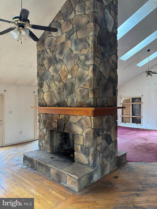 details with a skylight, a fireplace, and a textured ceiling